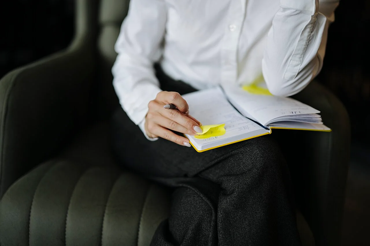 Hands of a person writing in a notebook